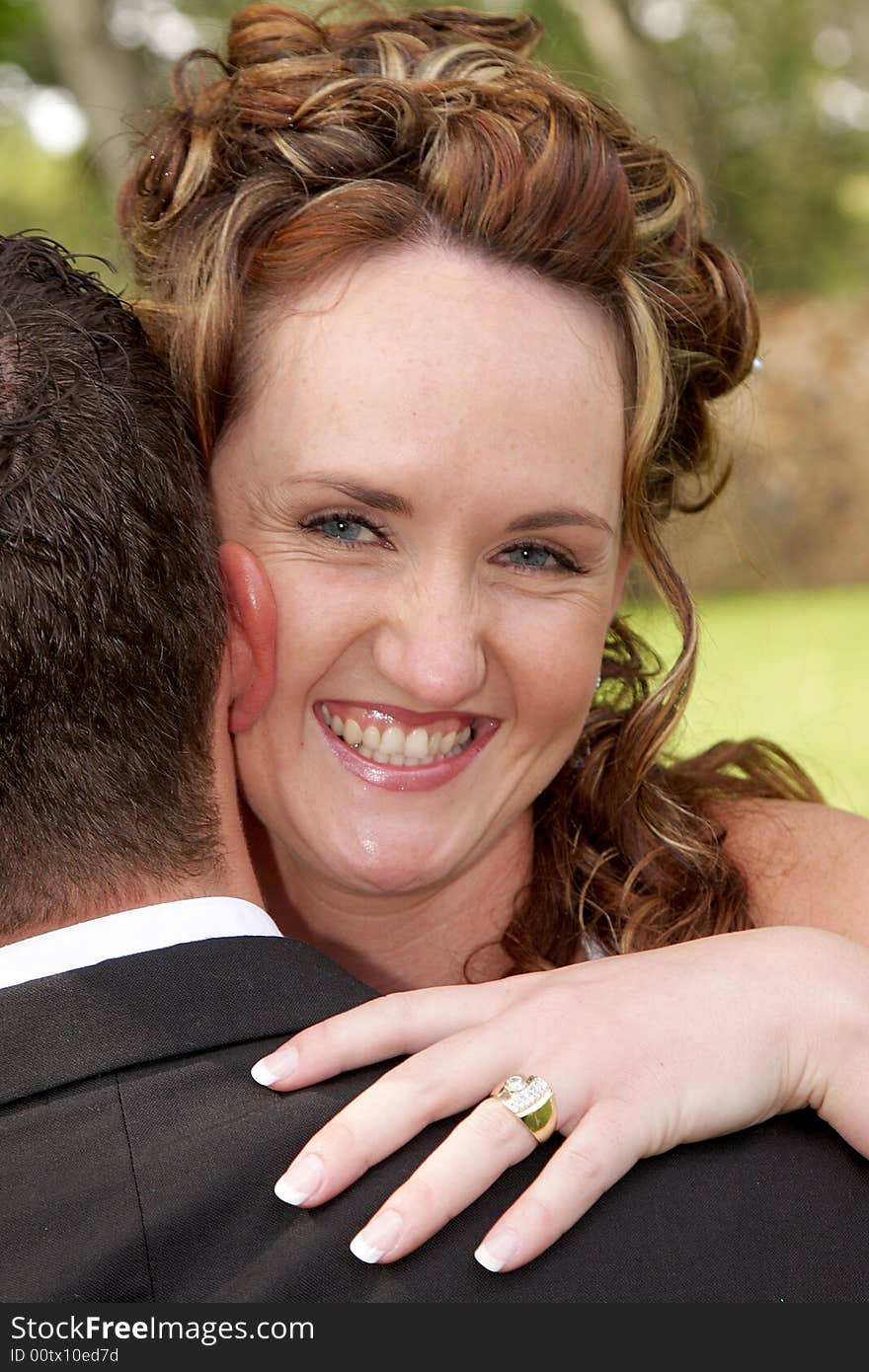 A bride looking over grooms shoulder. A bride looking over grooms shoulder