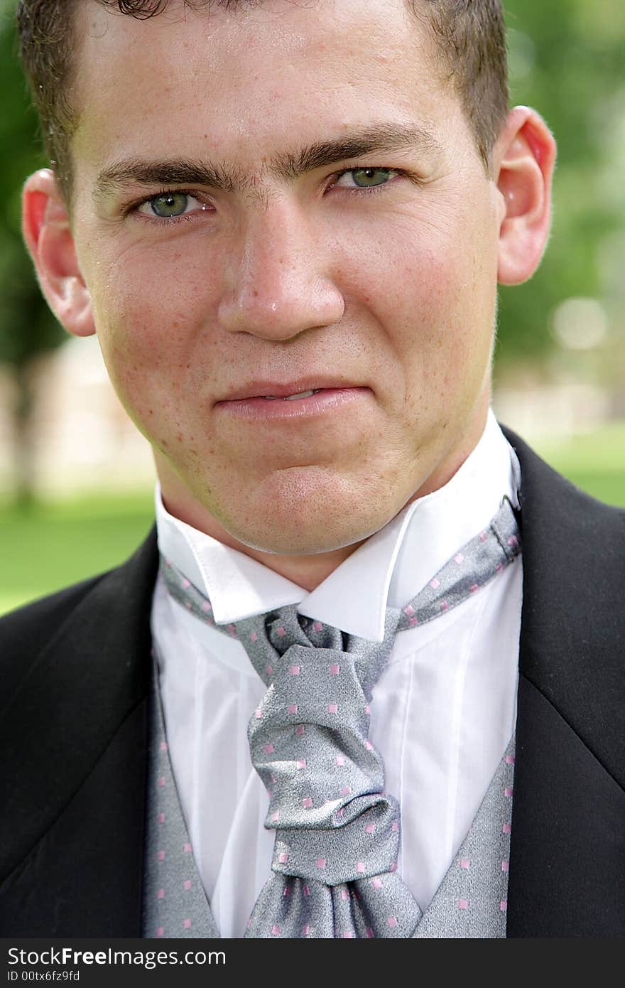 A groom standing outside on wedding day. A groom standing outside on wedding day