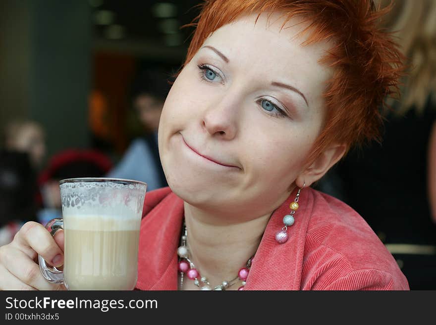 Woman drinking coffee in cafe and looking