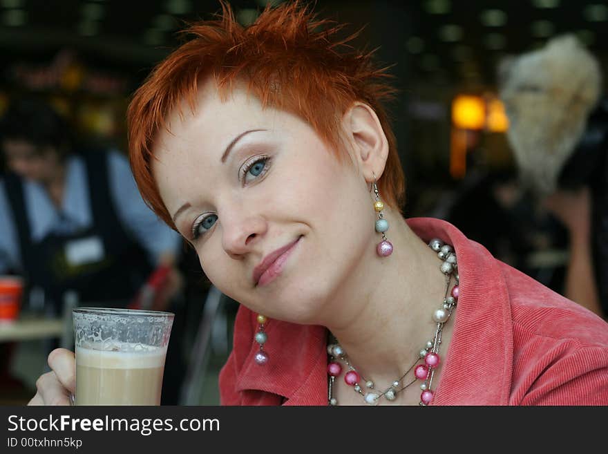 Woman drinking coffee in cafe and looking