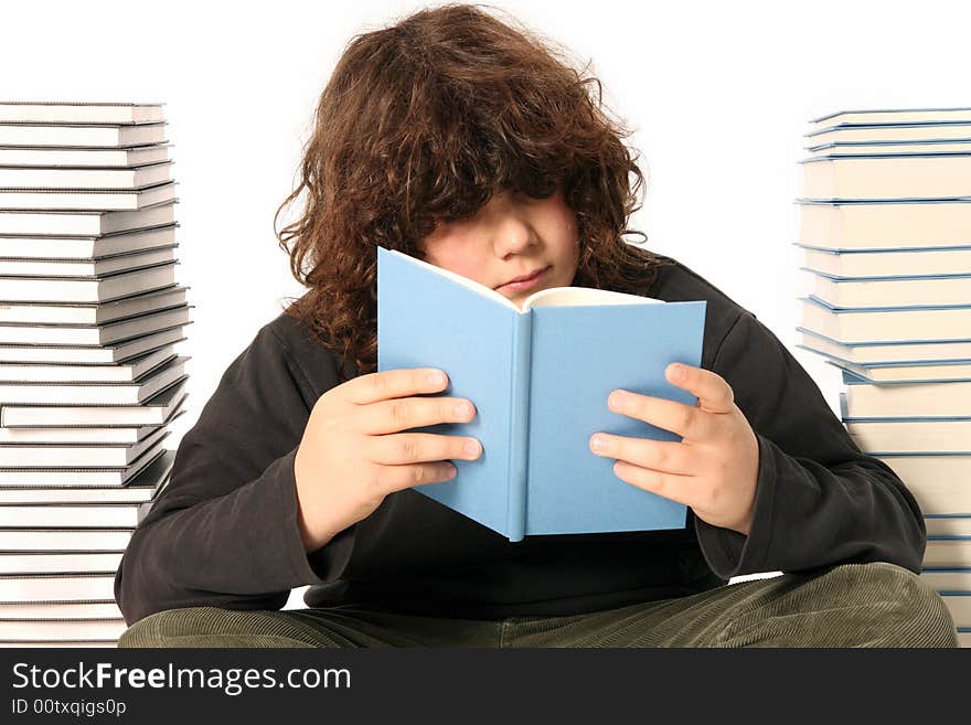 Boy reading a book and many books on white background