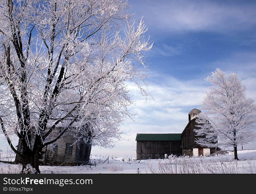 An old barn and farm house show their age as the house is ready to fall over. An old barn and farm house show their age as the house is ready to fall over