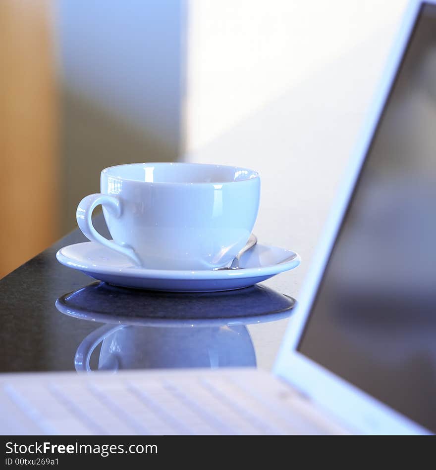 Laptop and white tea cup. Laptop and white tea cup