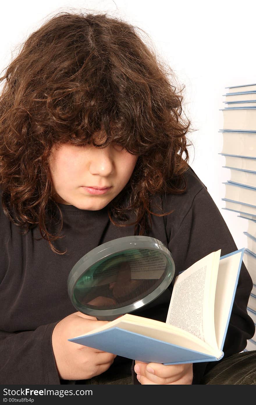 Boy reading a book with lens on white background