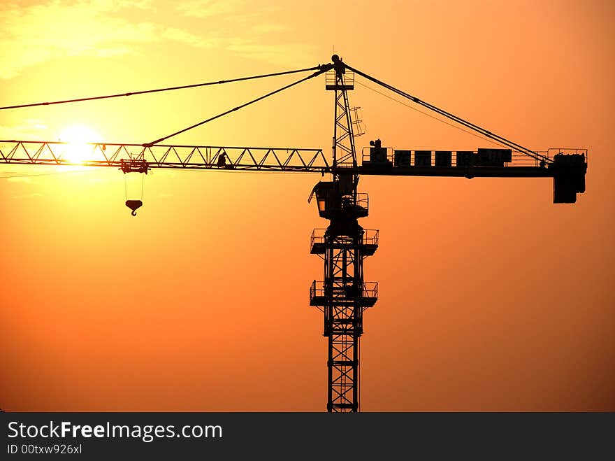 A high steel crane in the beautiful sunset and twilight. A high steel crane in the beautiful sunset and twilight.