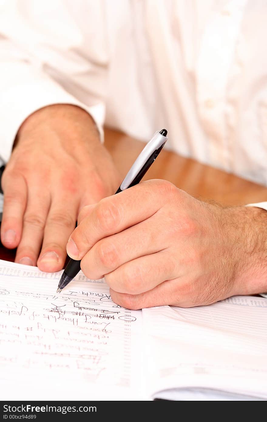 Close-up of businessman writing with pen. Close-up of businessman writing with pen