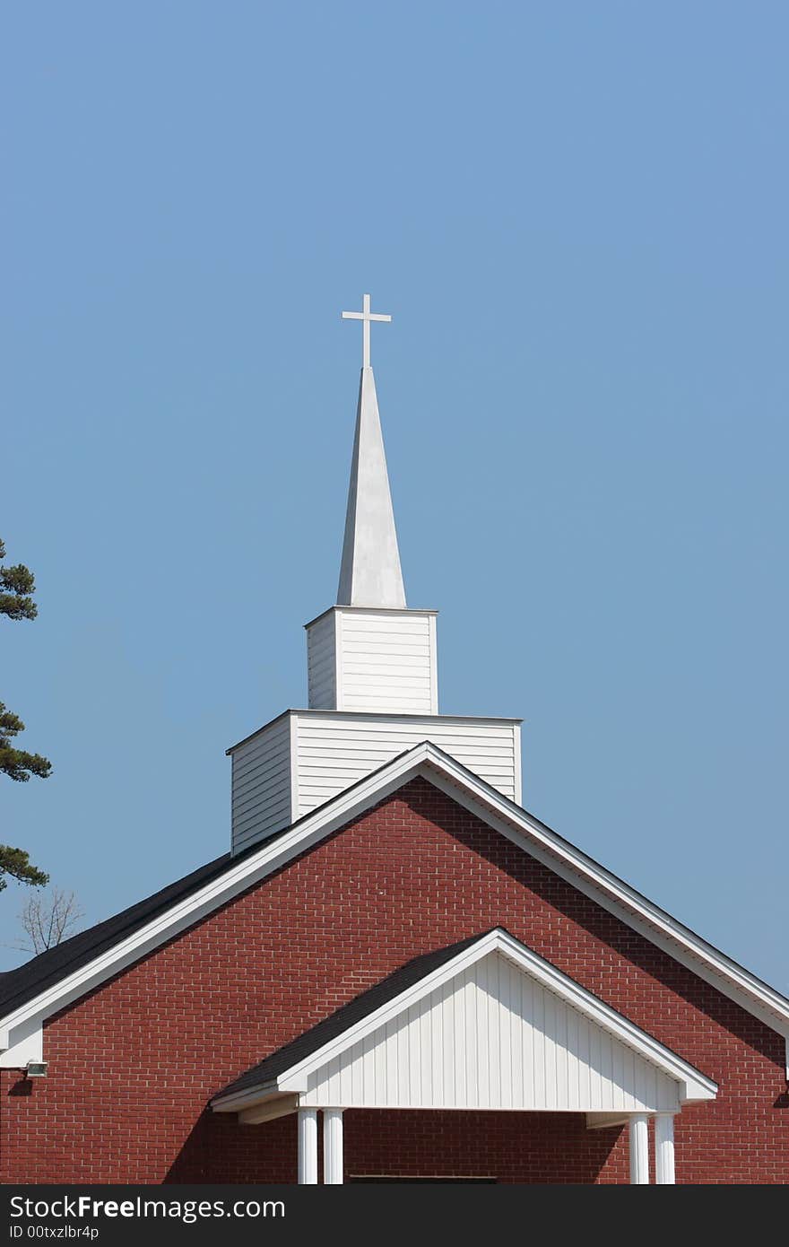 A church steeple rises into a clear, blue sky. A church steeple rises into a clear, blue sky