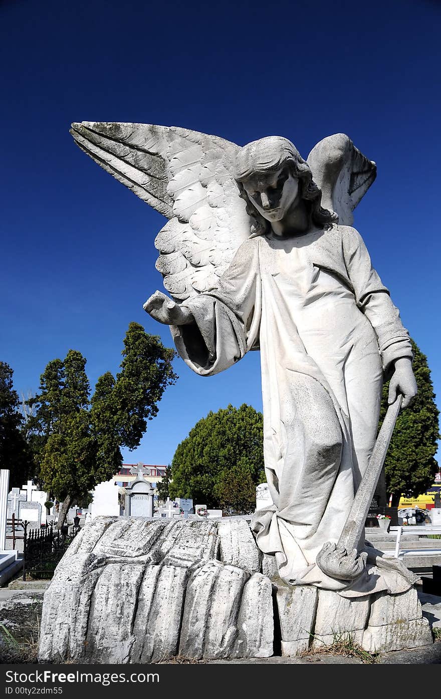 Image of a Stone Angel over a blue sky in cemetery