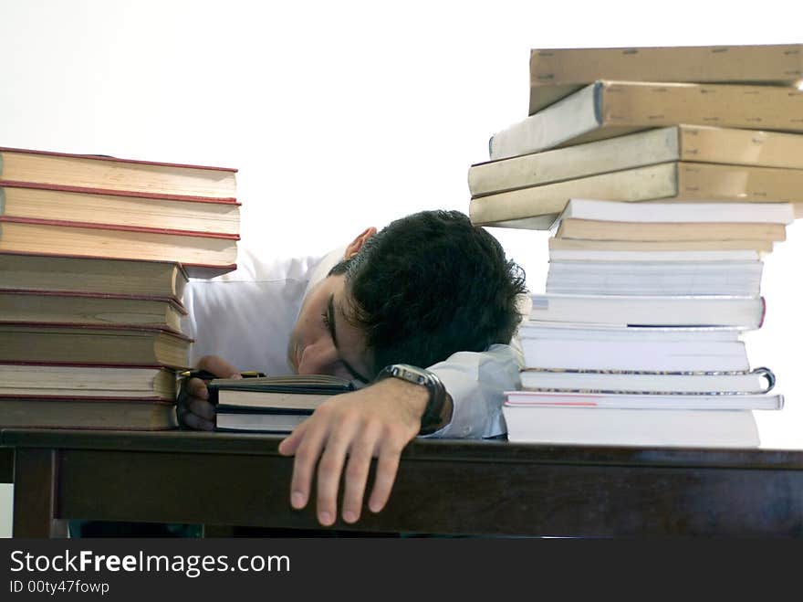 Man in business attire surrounded by books. Man in business attire surrounded by books