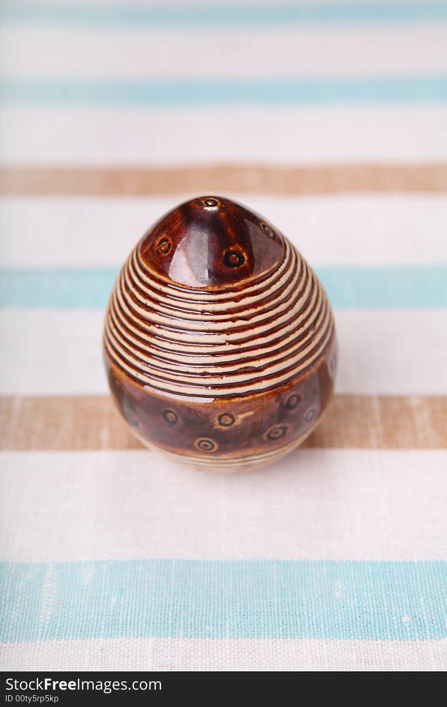 Easter egg - striped egg on striped cloth. Easter egg - striped egg on striped cloth