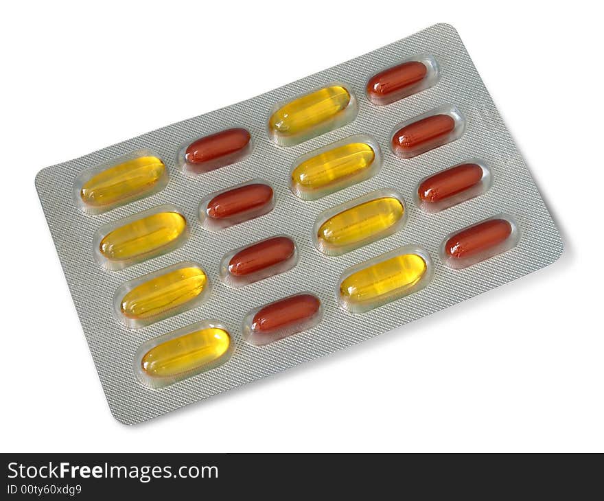 Pack of red and yellow vitamin pills isolated over white background. Pack of red and yellow vitamin pills isolated over white background