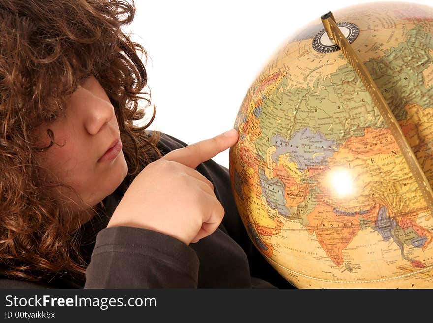 Boy finger pointing on world globe in isolated