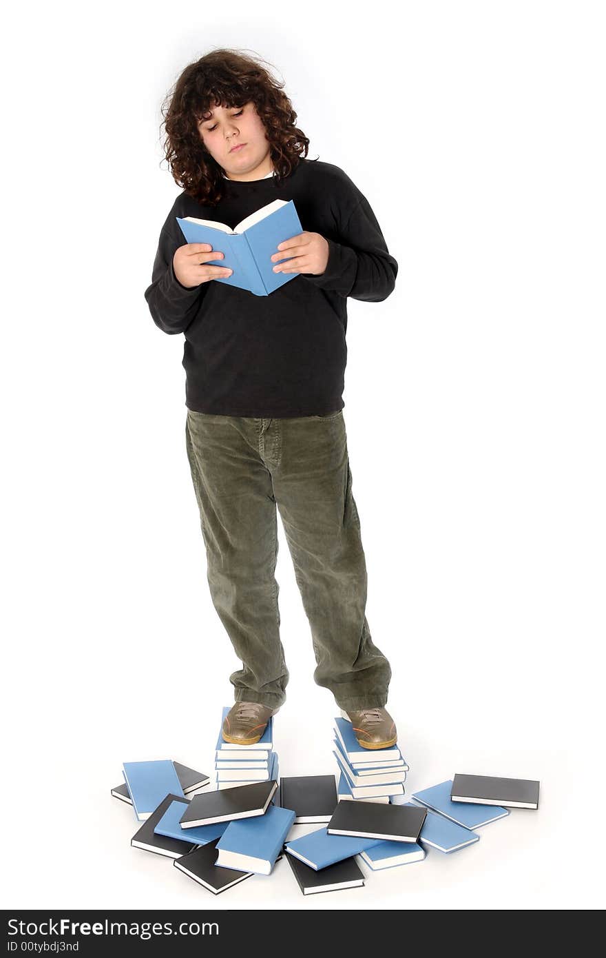 Boy on stack of books on white background