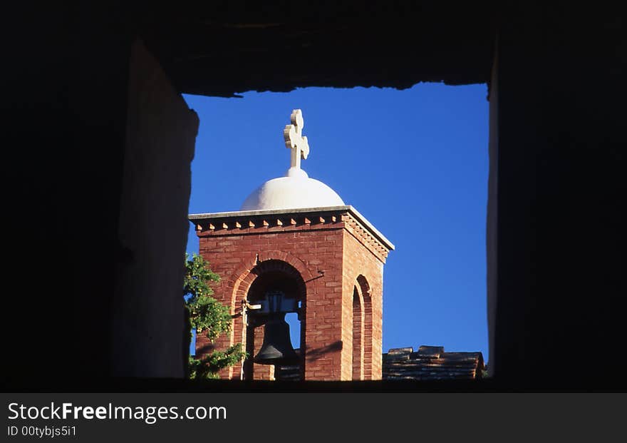 A tower church through a window. A tower church through a window