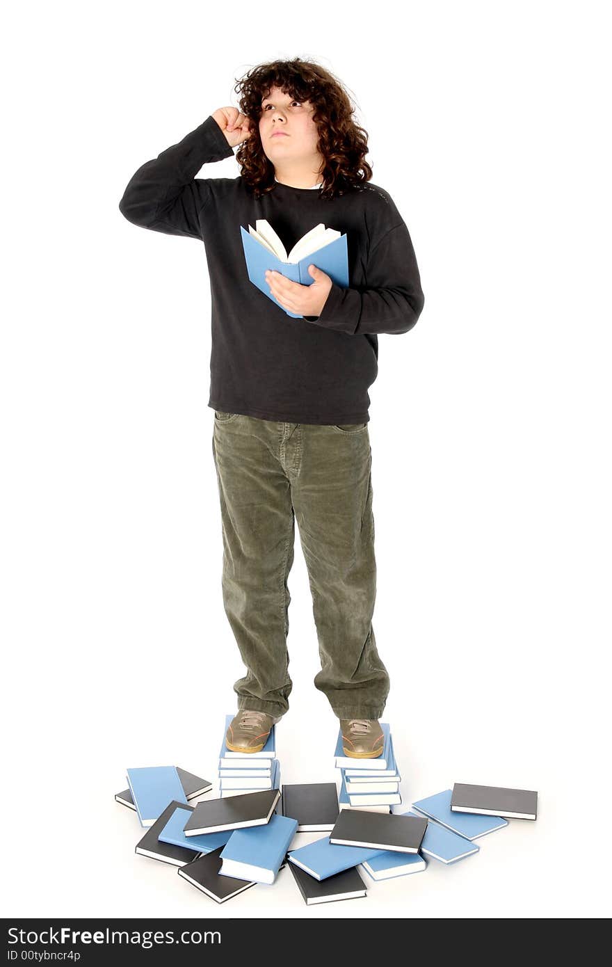 Boy on stack of books on white background