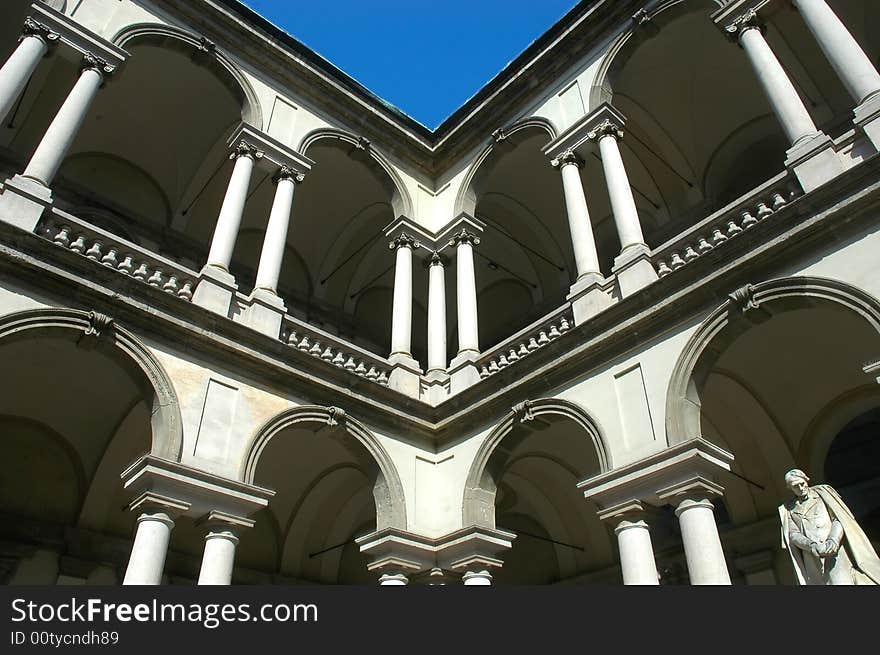 Historic building with white stones and sculpture under blue sky. Historic building with white stones and sculpture under blue sky