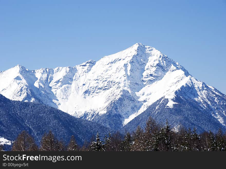 A close up of Legnone mountain after a snowfall - in italian Alps - in blue light. A close up of Legnone mountain after a snowfall - in italian Alps - in blue light