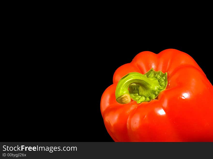 Single red Bell Pepper on a black background