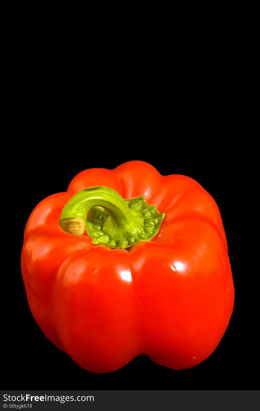 Single red Bell Pepper on a black background