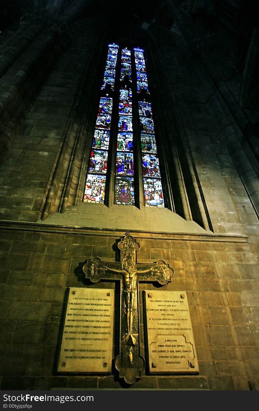 A cross under stained-glass window