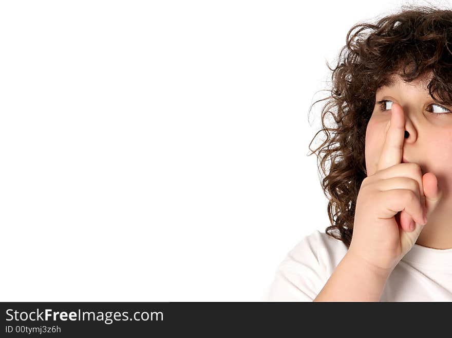 Boy gestures for silence on white background