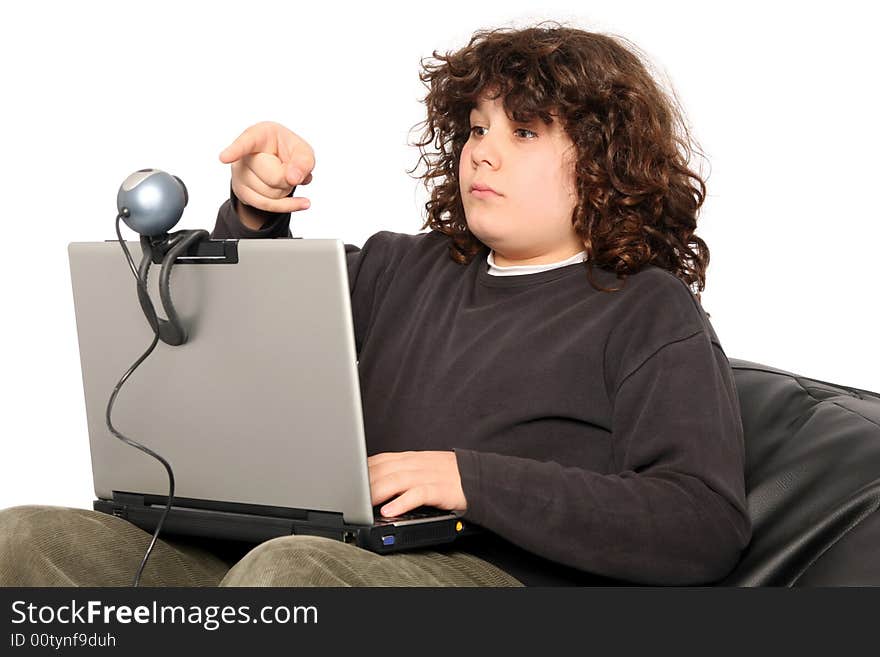 Boy using laptop and webcam on white background