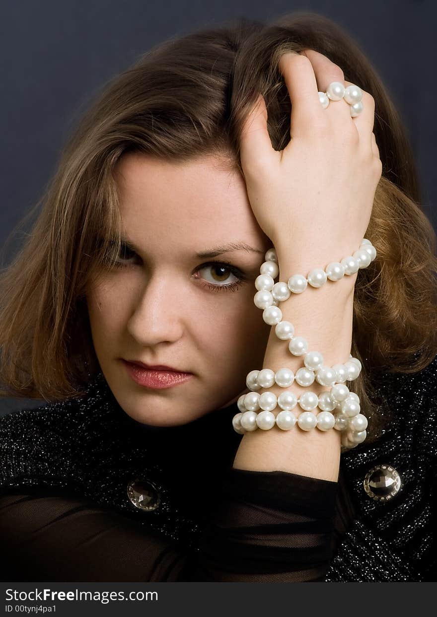 Retro-styled girl with beads on hand