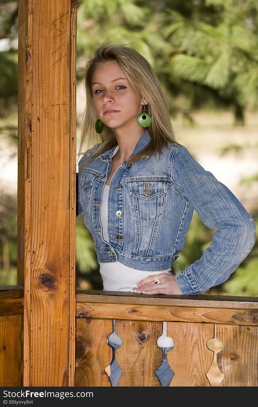 A beautiful young blonde girl in a gazebo. A beautiful young blonde girl in a gazebo