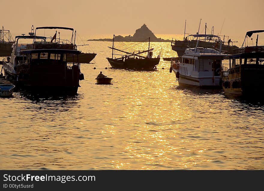 The fisher is in the Sunset of the sea