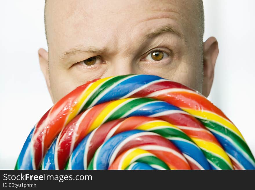 Man Peeking Out From Behind A Lollipop