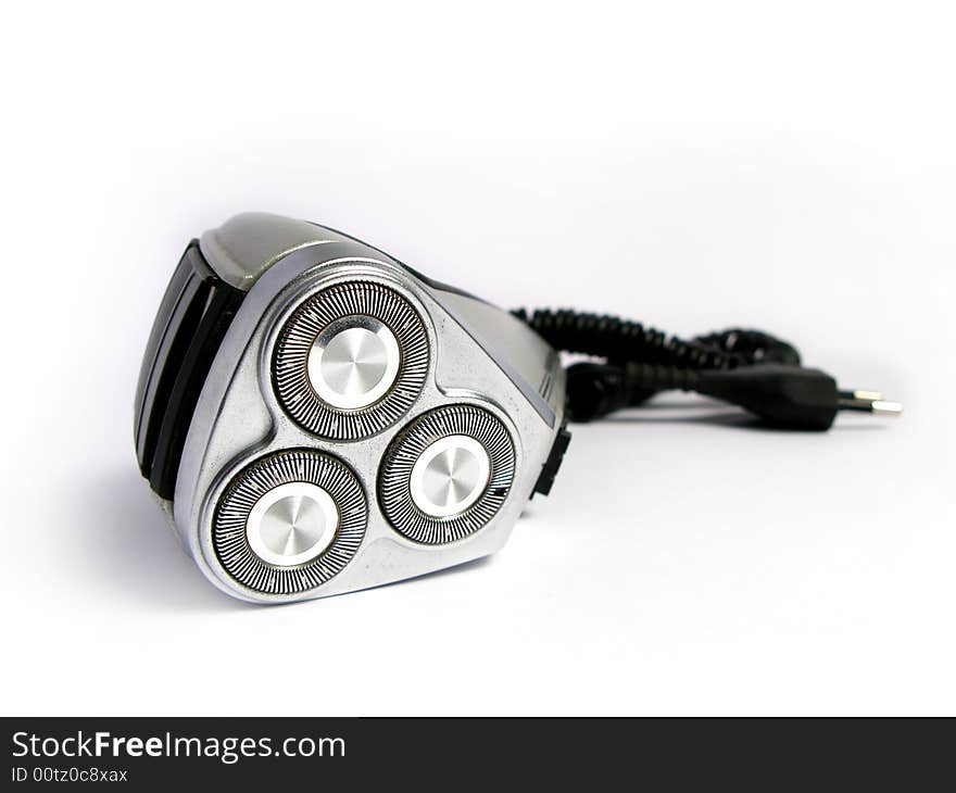 A silver and black electric shave machine, in white background. A silver and black electric shave machine, in white background.