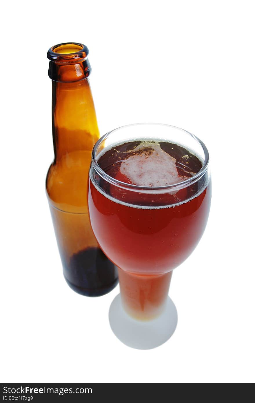 Glass of a German lager beer with a bottle, isolated on white.  Clipping path is included. Glass of a German lager beer with a bottle, isolated on white.  Clipping path is included.