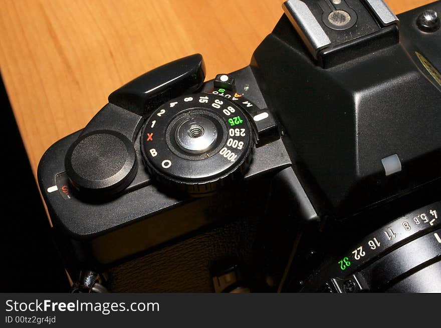 Old film camera detail - winding lever, shutter control, hot shoe, and aperture control. Old film camera detail - winding lever, shutter control, hot shoe, and aperture control.