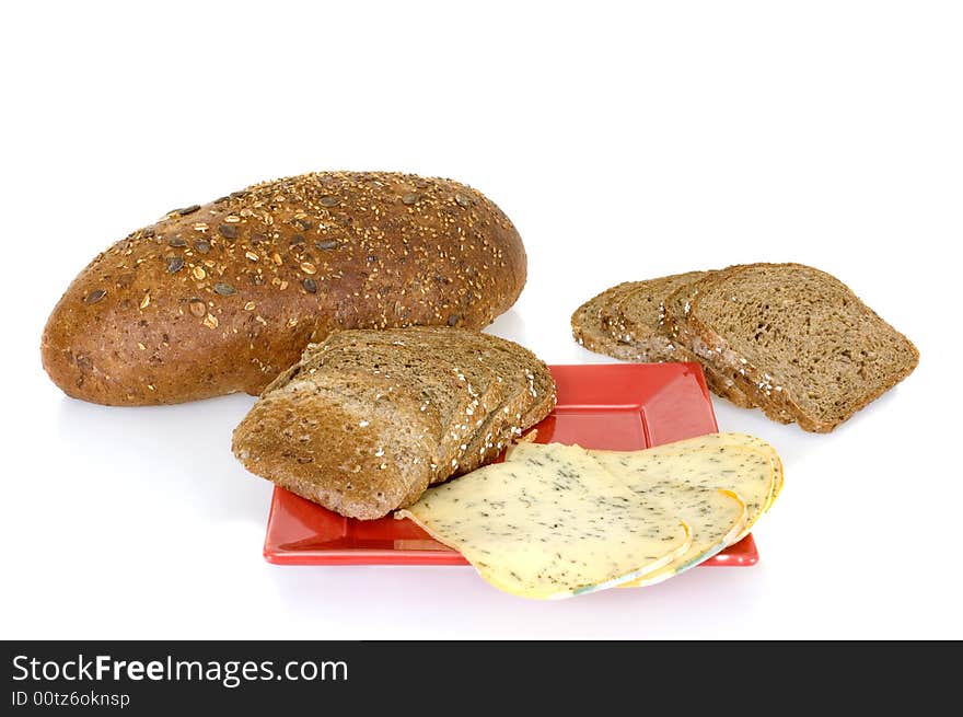 Bread and cheese on red platter, white background, reflective surface