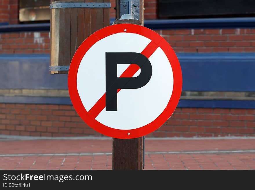 A no parking sign next to a road