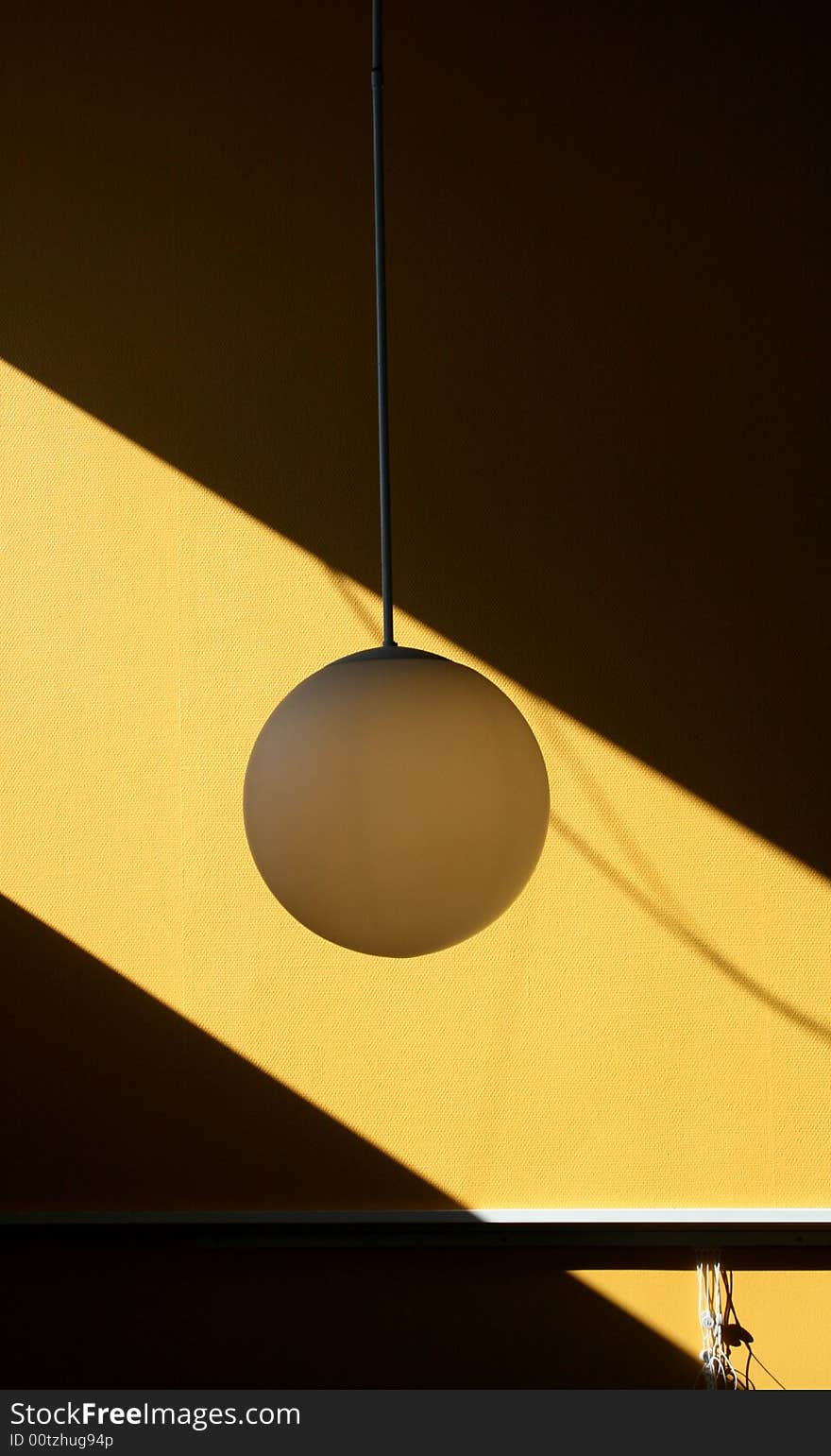 Lamp hanging down from the roof framed by sunlight. Lamp hanging down from the roof framed by sunlight