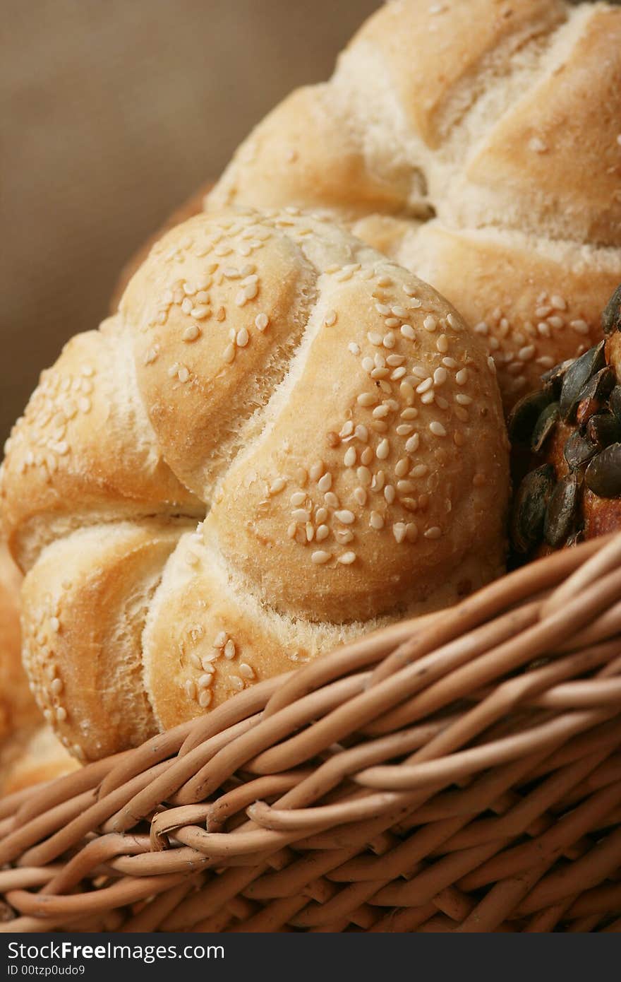 A closeup of a different bread with wheat grains and stalks placed next to it. A closeup of a different bread with wheat grains and stalks placed next to it.