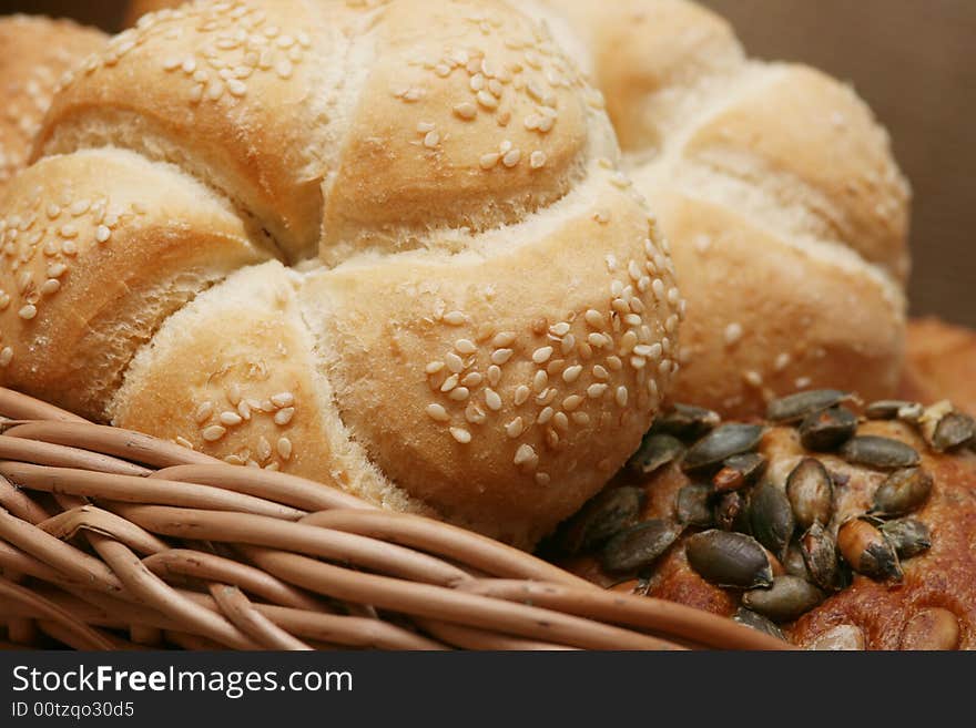 A closeup of a different bread with wheat grains and stalks placed next to it. A closeup of a different bread with wheat grains and stalks placed next to it.