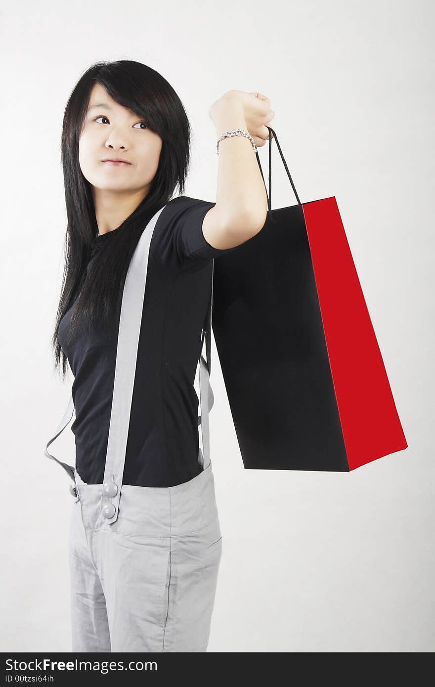 Shopping in a Chinese girl carrying a shopping bag.