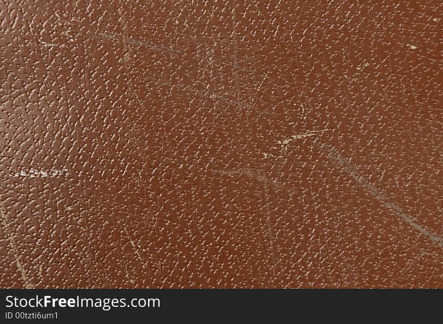 Brown leather texture with visible wear and tear. Brown leather texture with visible wear and tear