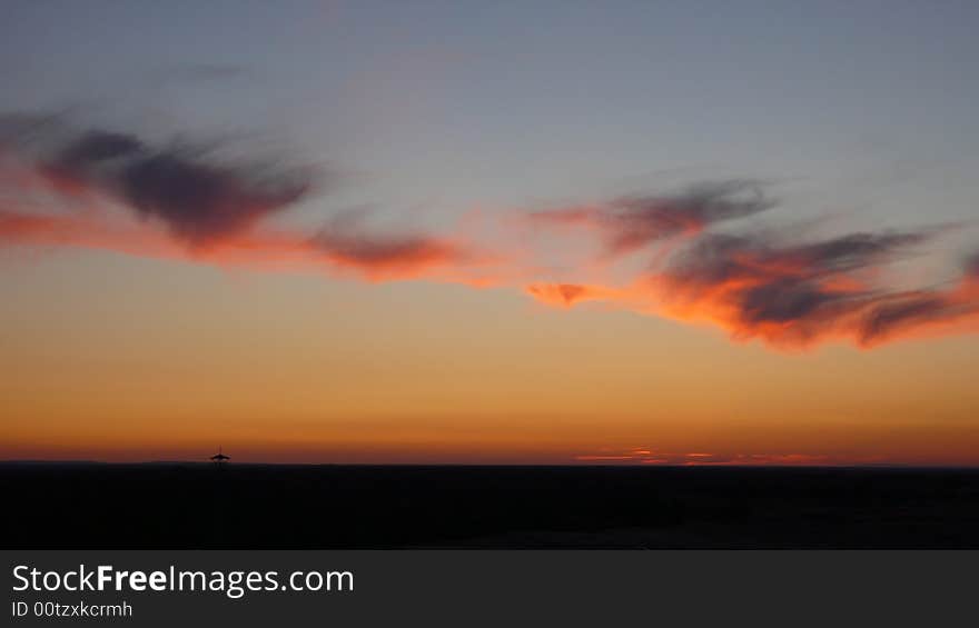 The sunset with the colourful cloud behind it is a beautiful sight.
. The sunset with the colourful cloud behind it is a beautiful sight.