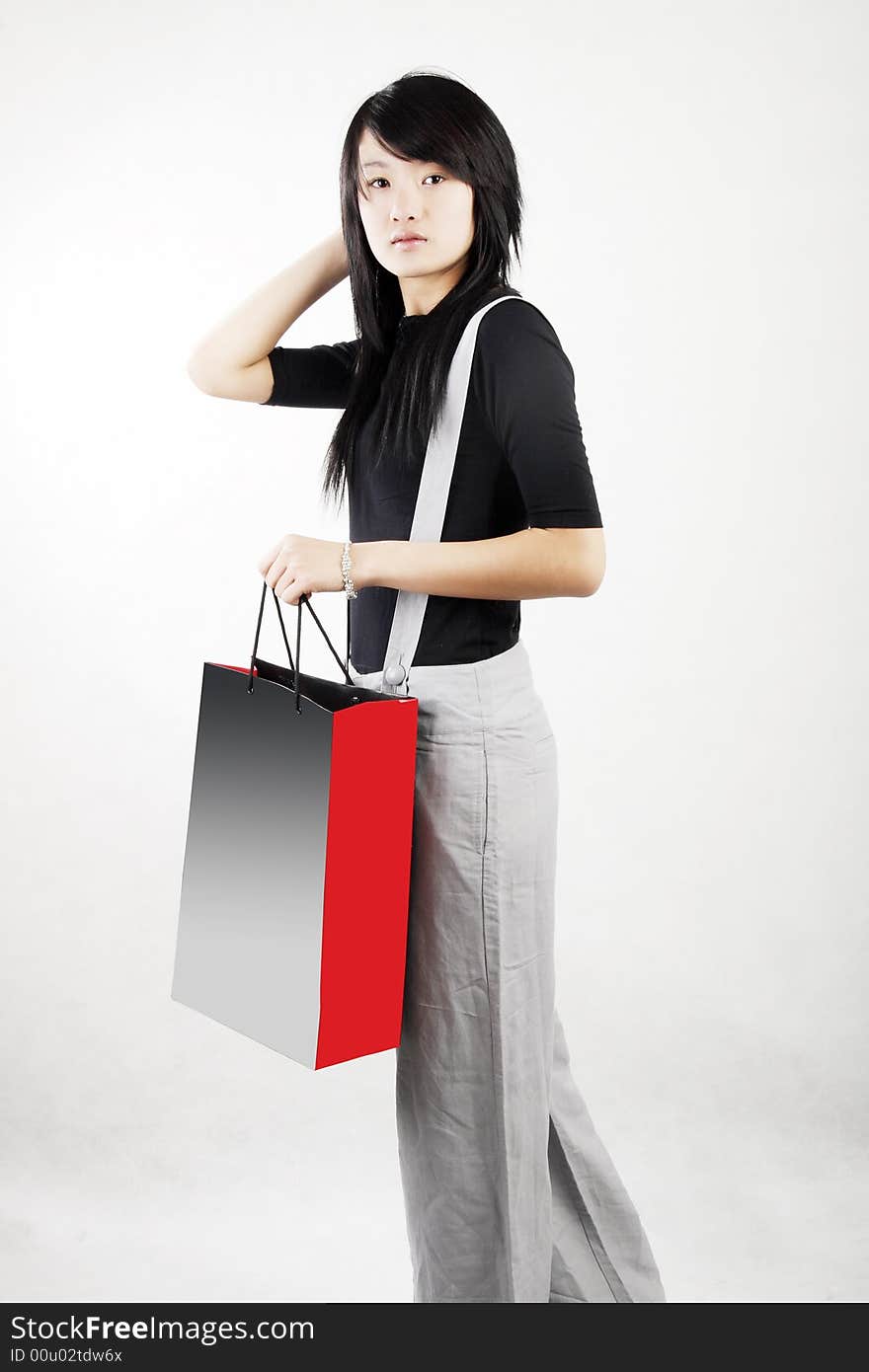 Shopping in a Chinese girl carrying a shopping bag.happy shopping