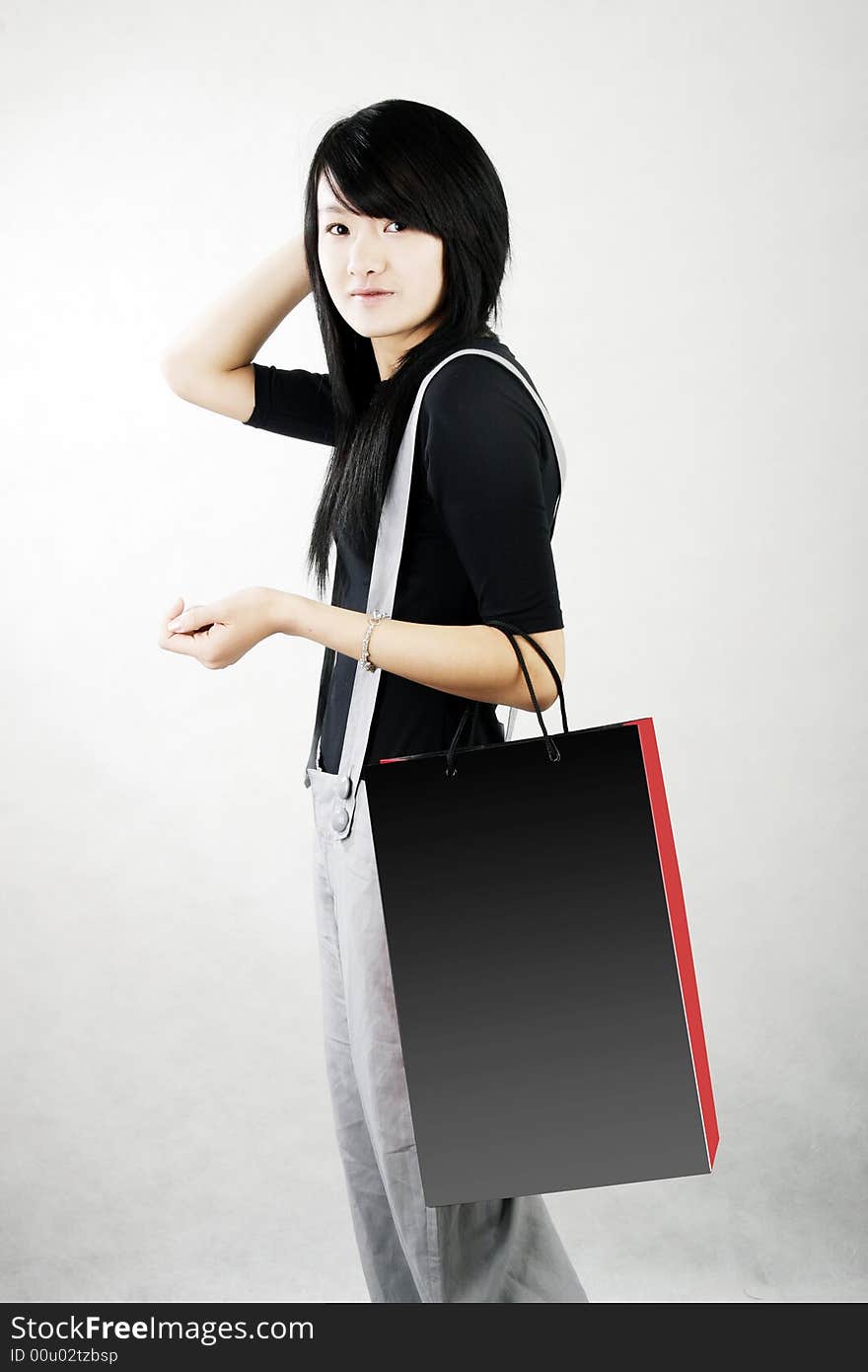 Shopping in a Chinese girl carrying a shopping bag.happy shopping