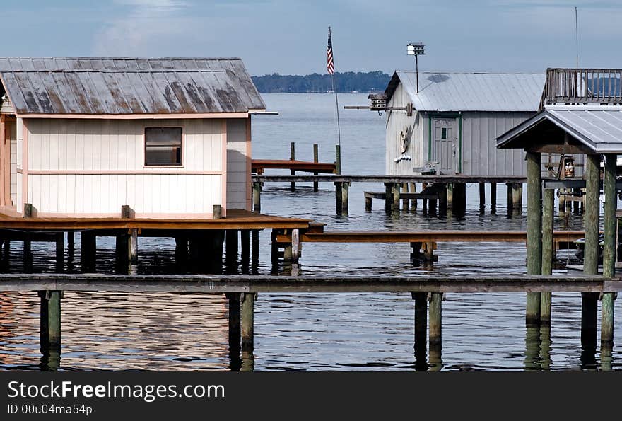 Portions of dock houses and boat shelters over water.