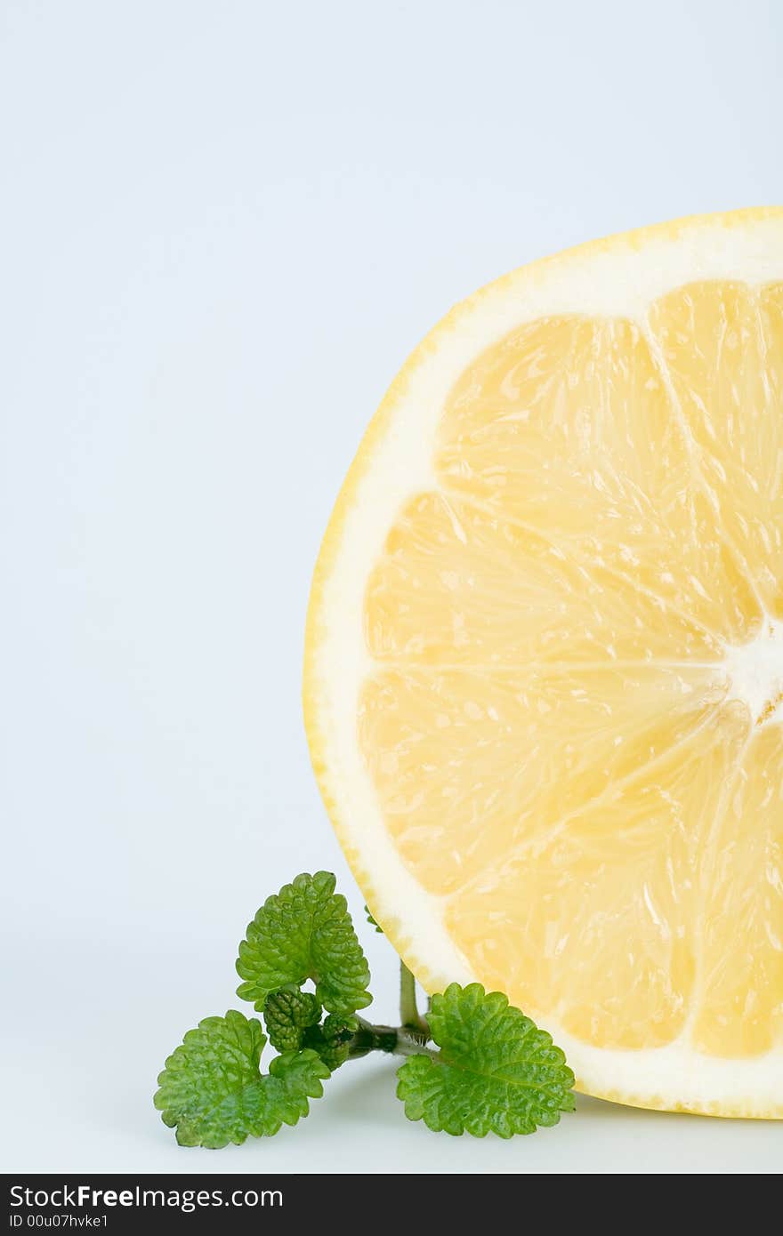 Sliced grapefruit with fresh balm, isolated