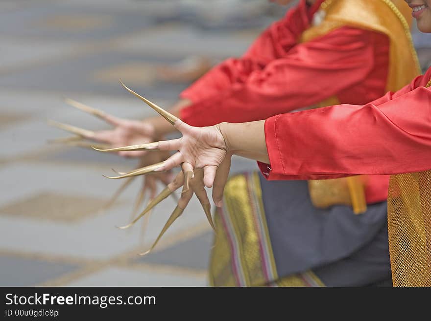 In a traditional Thai dance performance, the dancers long artificial fingernails