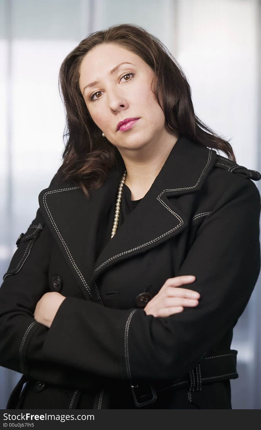 Hispanic Woman With Her Arms Crossed Wearing Pearls