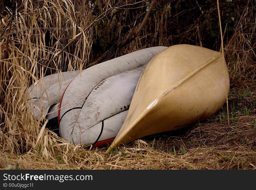 Abandonded canoe and rafts in a marshy area. Abandonded canoe and rafts in a marshy area