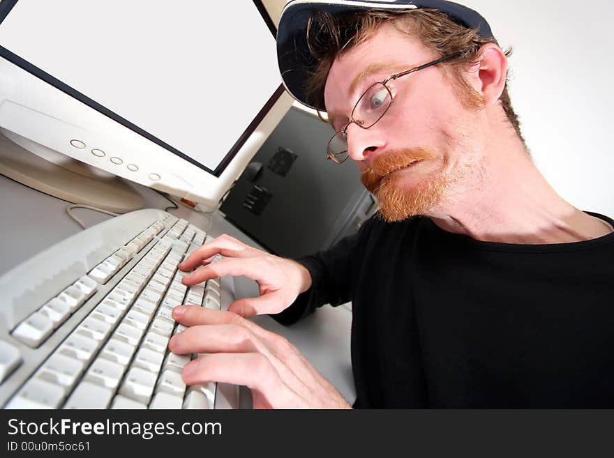 Mad programmer sitting at a computer desk