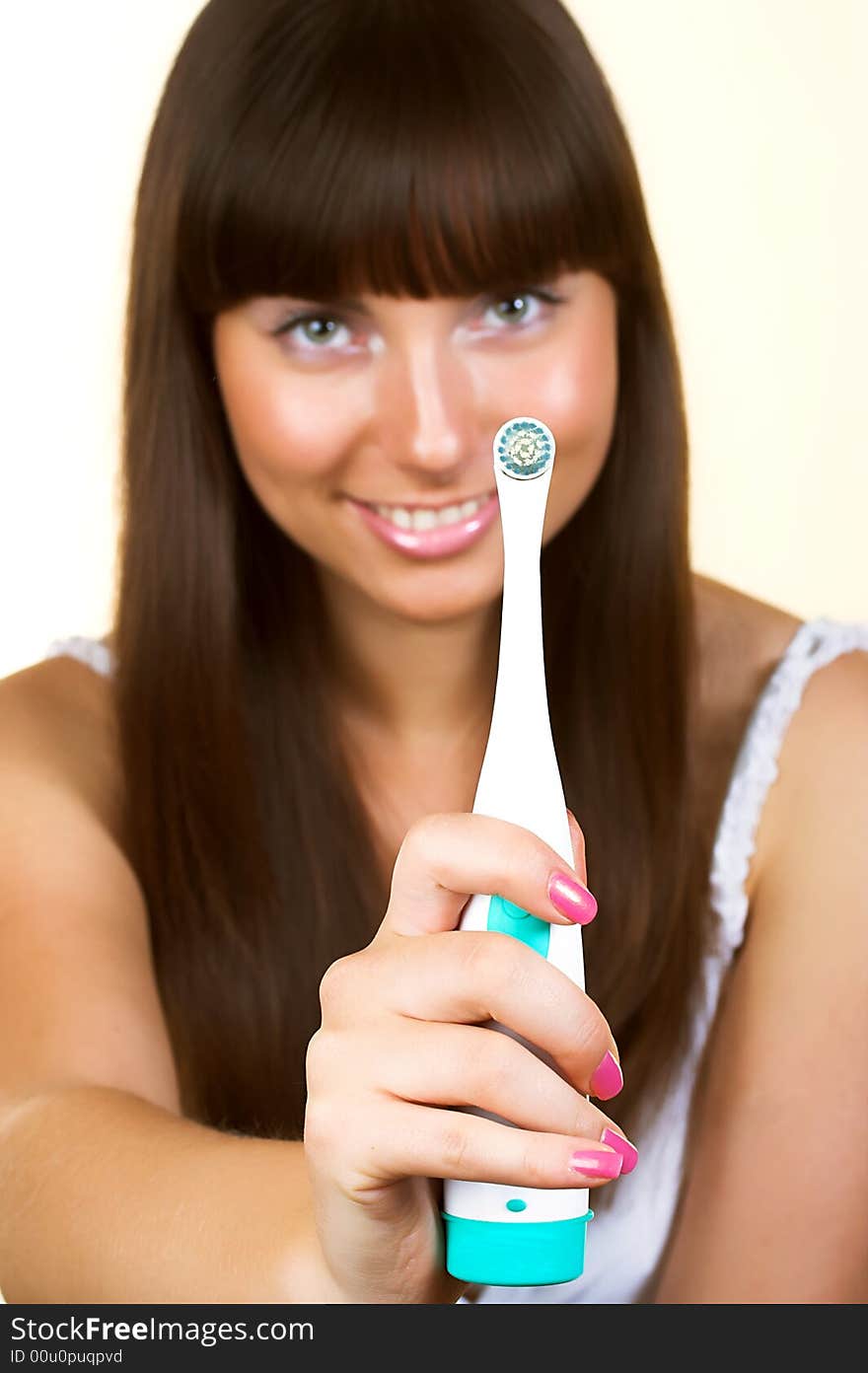 Young beautiful smiling woman with great white teeth holding a toothbrush. Young beautiful smiling woman with great white teeth holding a toothbrush